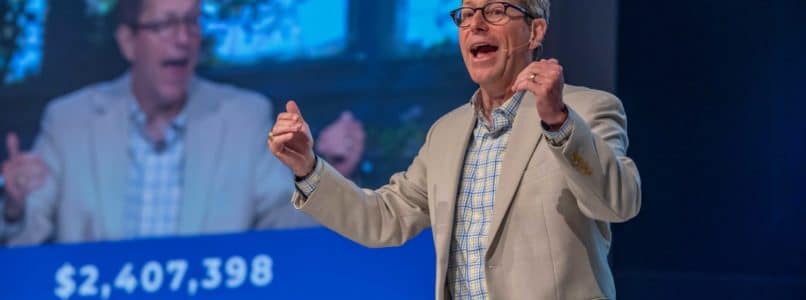 Gregg Matte, senior pastor of Houston’s First Baptist Church, celebrates the record World Mission Offering on Easter Sunday, April 4. The total in the background grew by 0,000 over the following days. (Photo by Richard Carson, courtesy of HFBC)